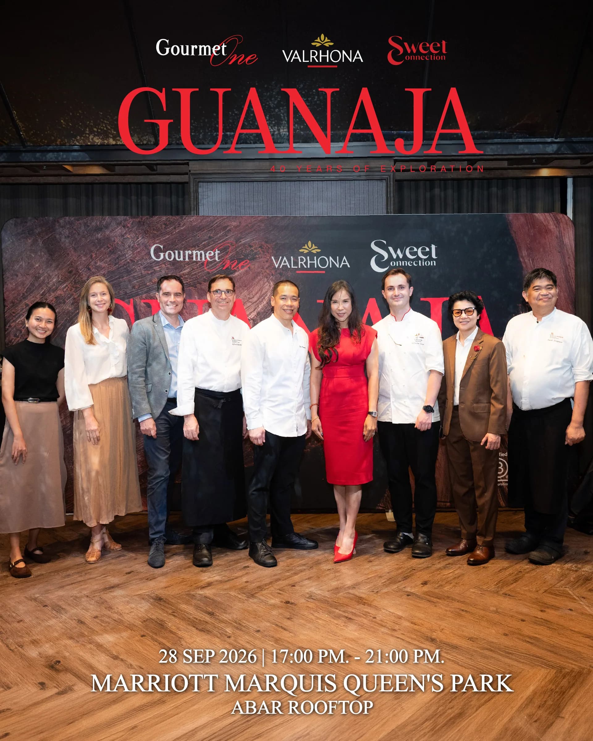 Chefs and event partners gathered beneath the Guanaja 40 Years of Exploration artwork.
